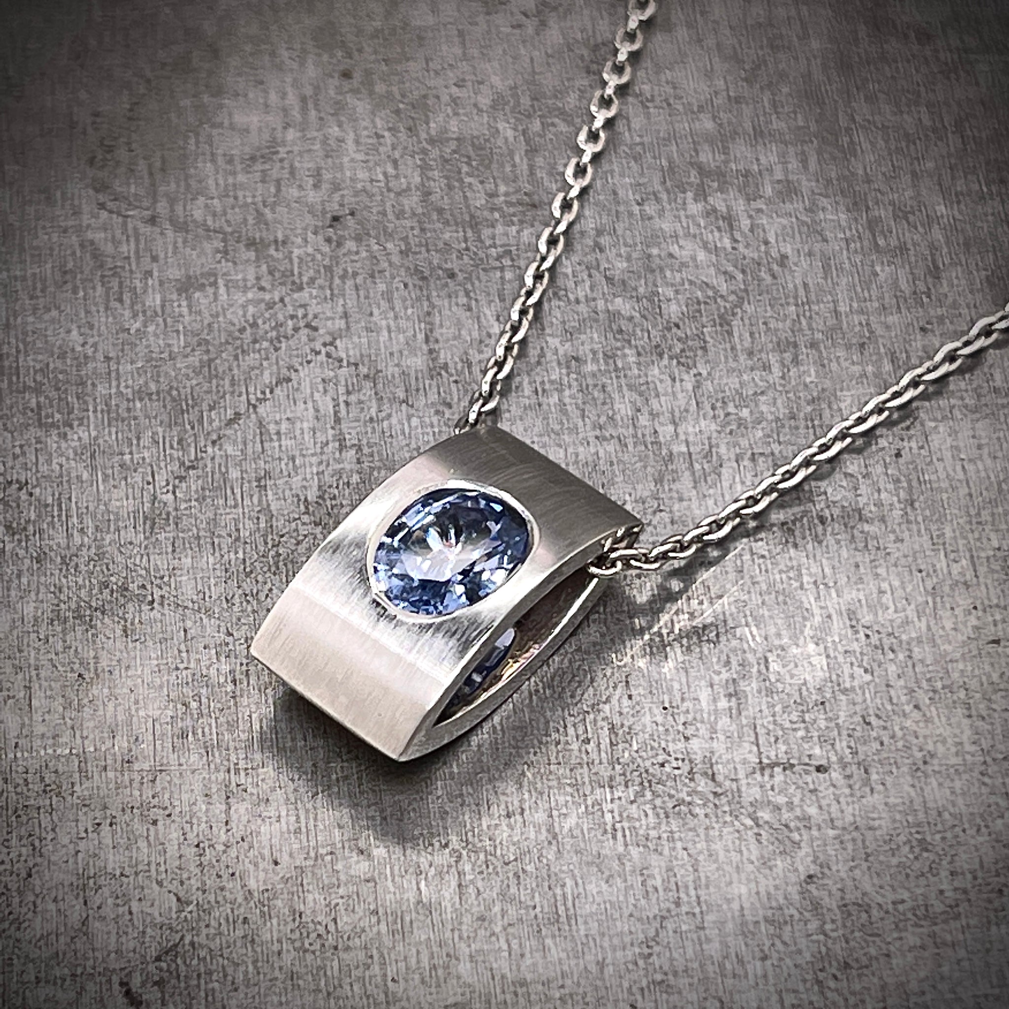 Angled view of 18k White Gold Pale Blue Sapphire Necklace