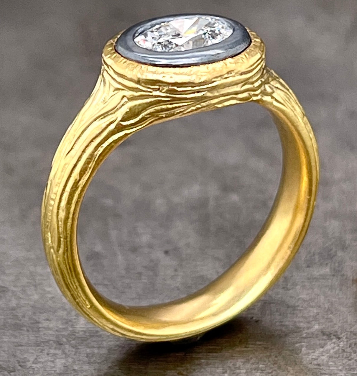 Side angled view of salt and pepper diamond ring standing up.
