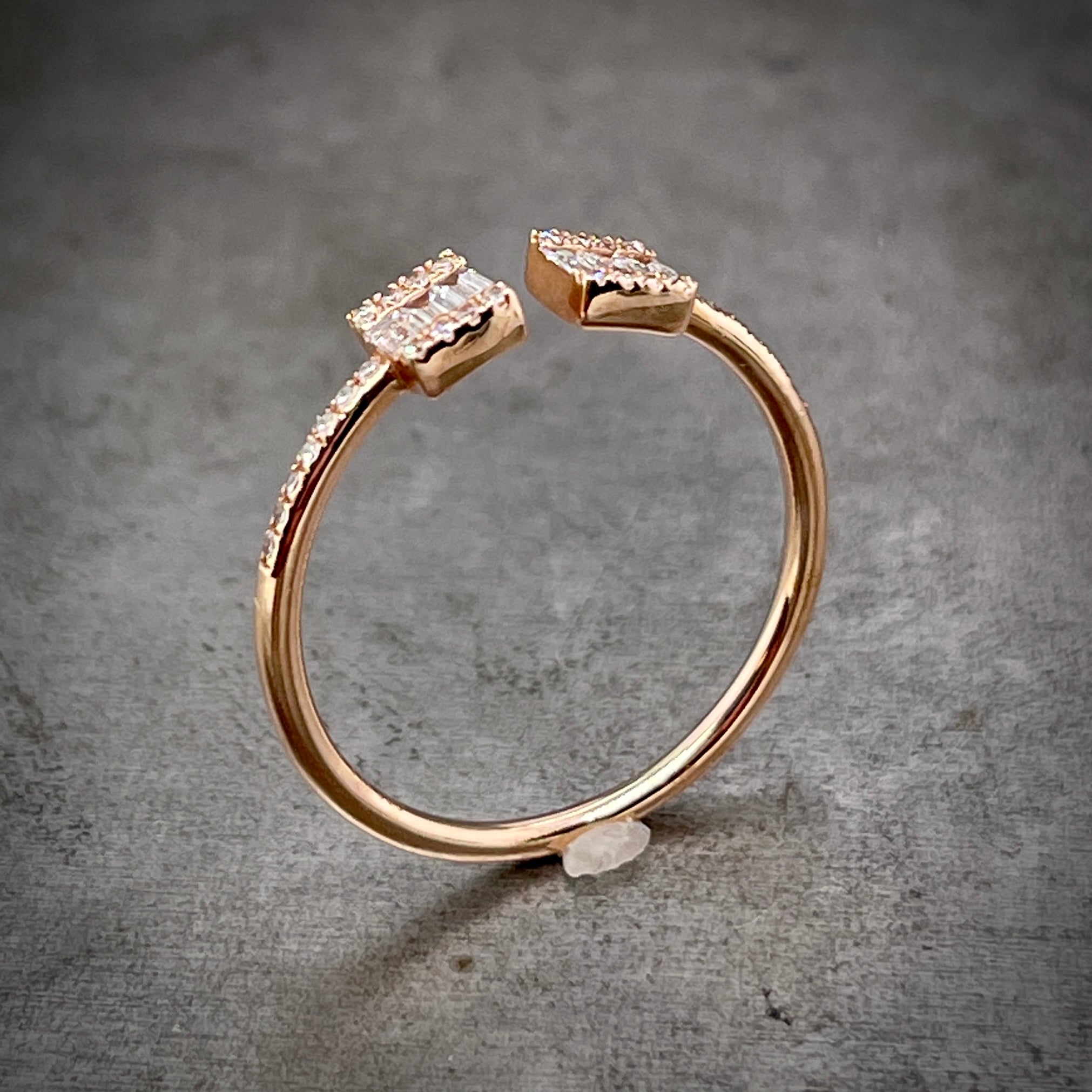 Angled aerial view of rose gold negative space ring standing up.