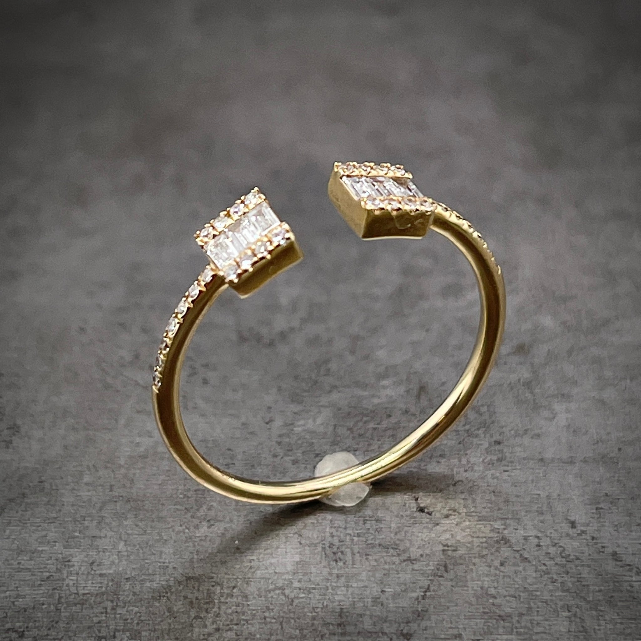 Angled aerial view of yellow gold negative space diamond ring.