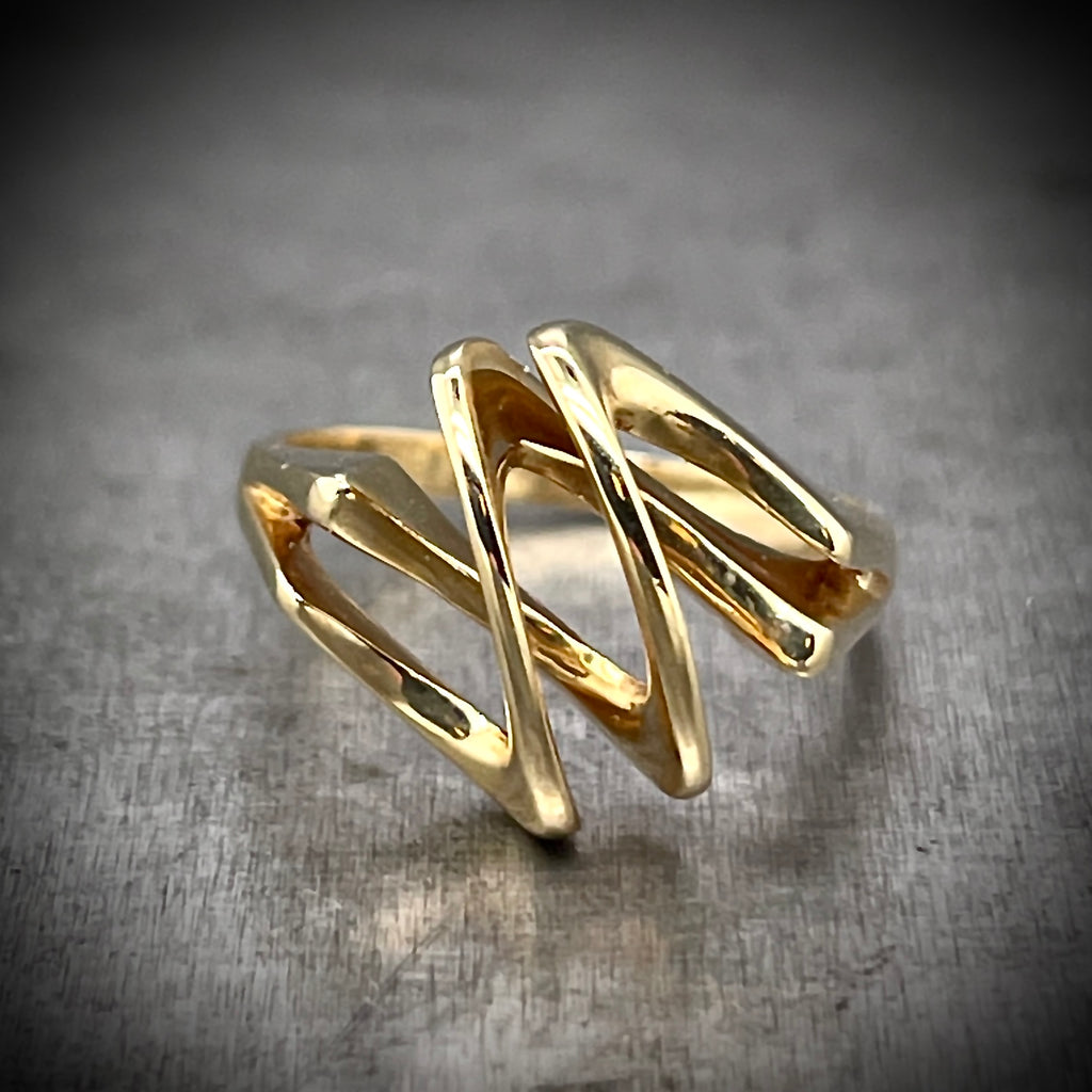 Frontal view of Folded Gold Ring. The two gold wires are parallel to one another and fold over themselves create hatched diagonal lines.