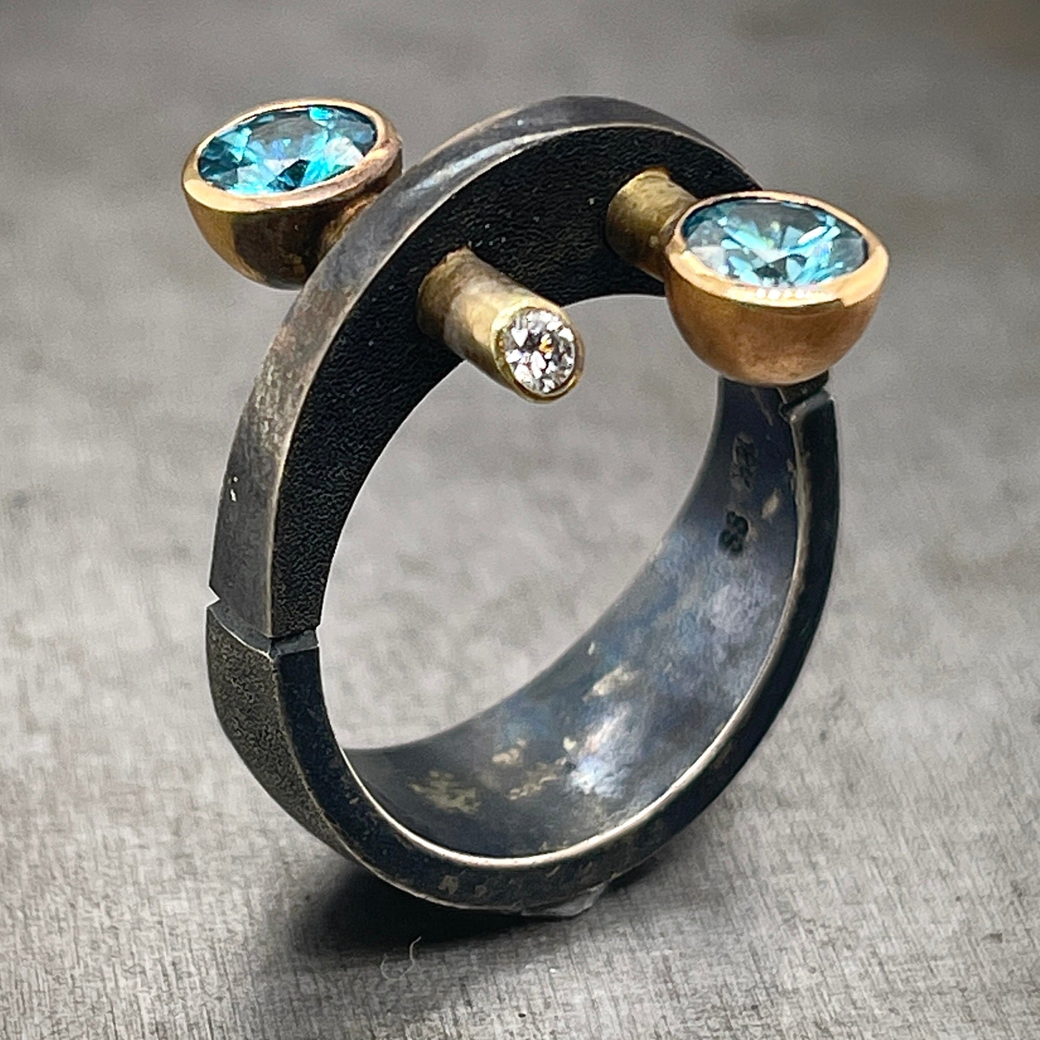Oxidized Sterling Silver and Gold, Blue Zircon and Diamond Ring. The ring is upright, turned to display a 3/4 view.