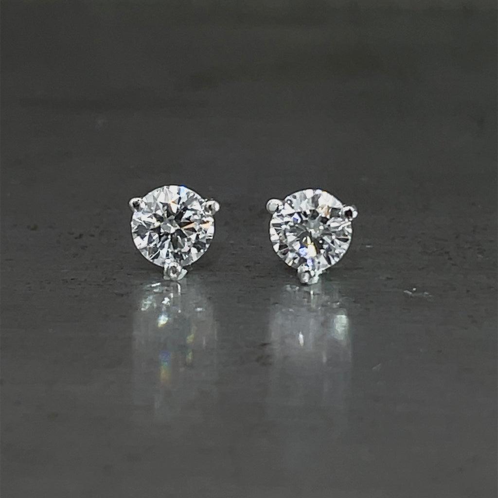Front view of 1.08 cttw round brilliant lab grown diamond three-prong martini stud earrings.