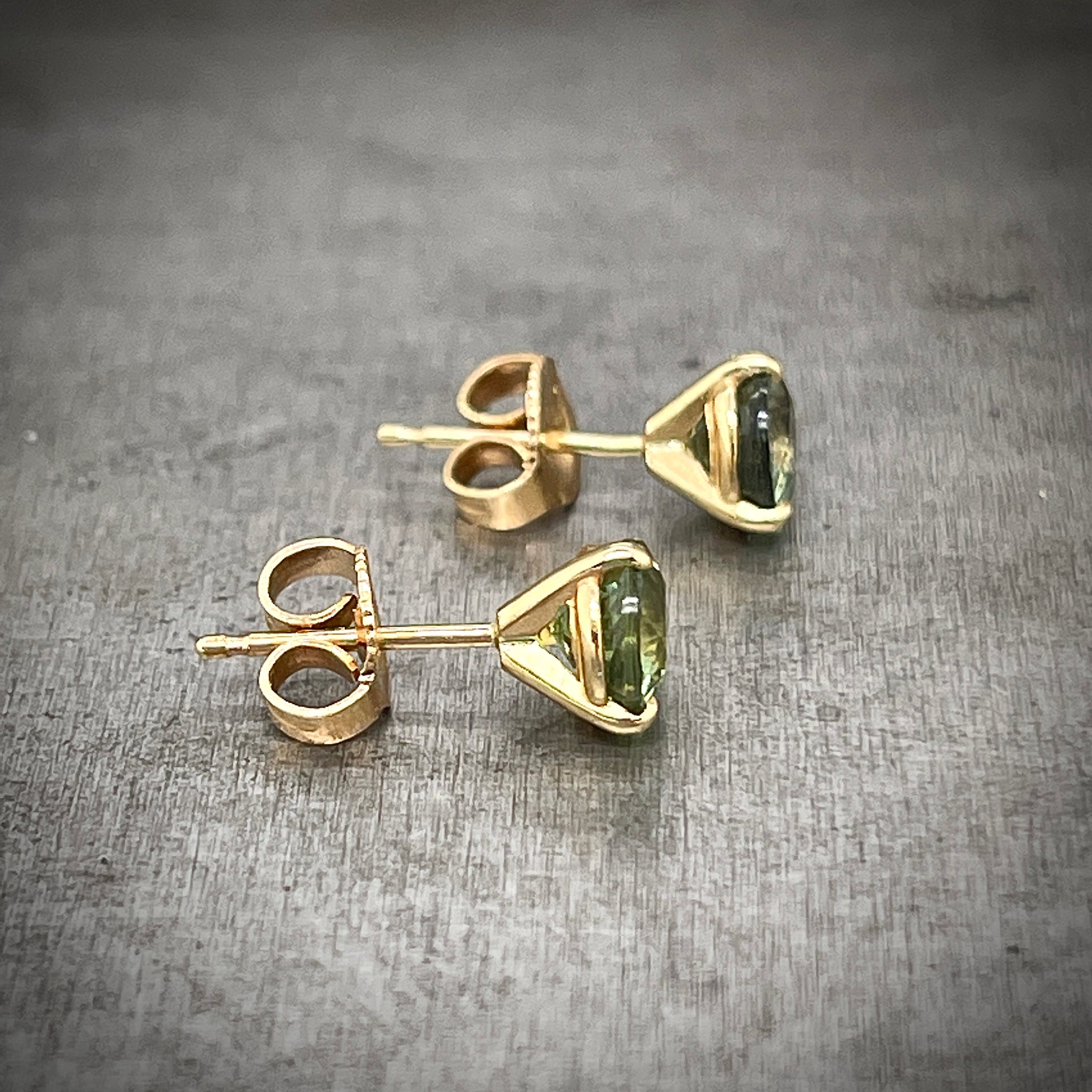Side View of 14K Yellow Gold Green Sapphire Studs displaying Martini Setting and Friction Backs