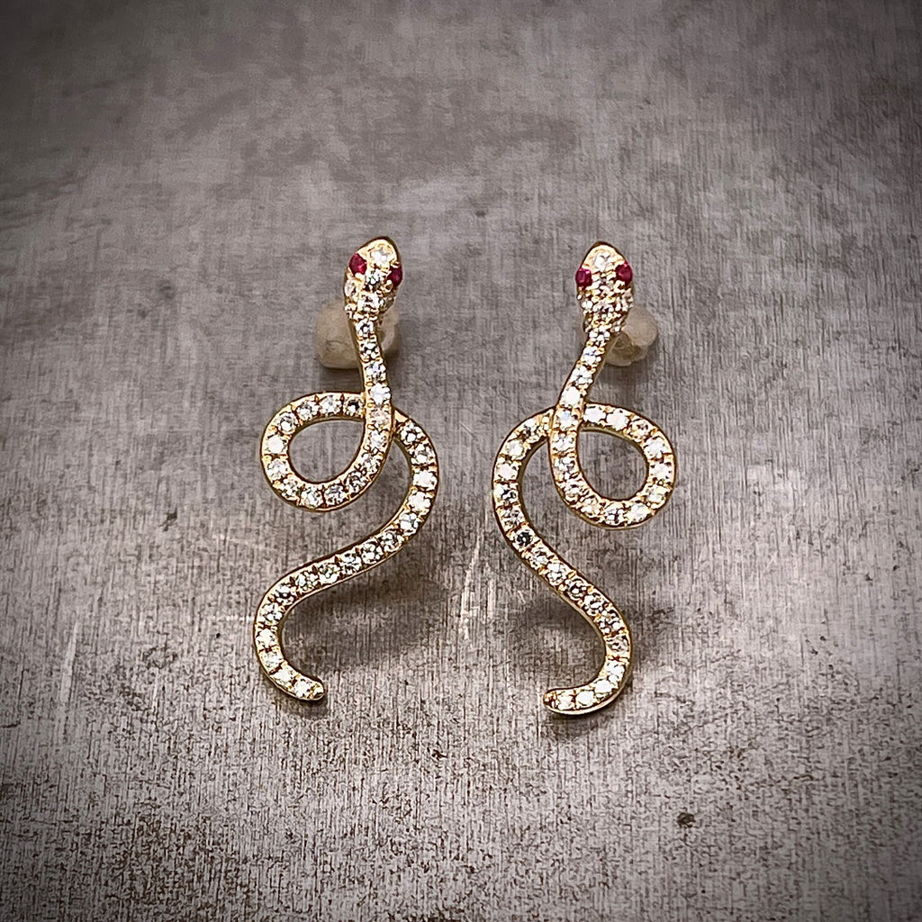 Front view of Diamond and Yellow Gold Snake Earrings with Ruby Accents