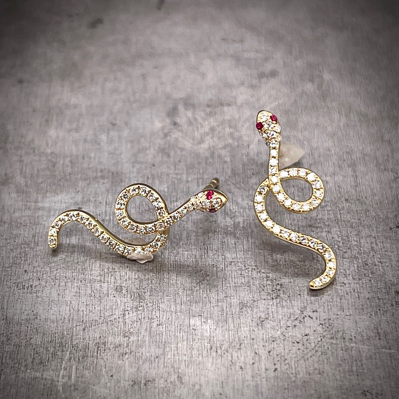 Front View of Diamond and Yellow Gold Snake Earrings with Ruby Accents