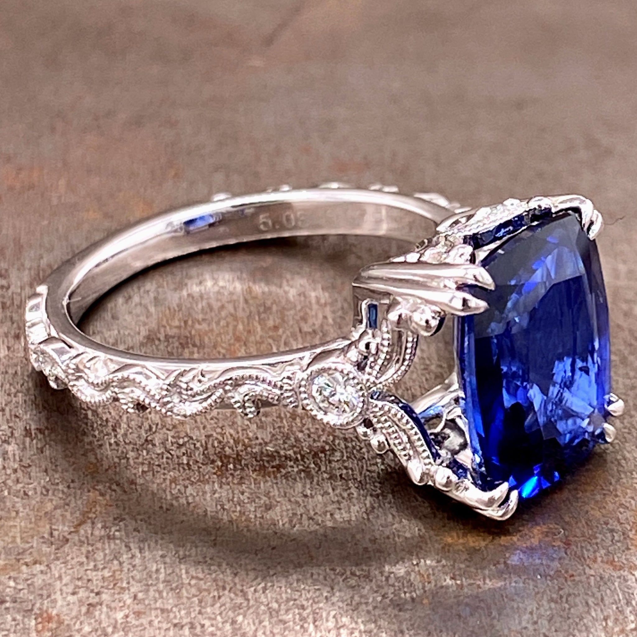 Side view of sapphire and 14 karat white gold ring.