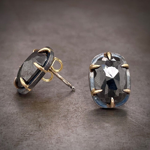 Side and frontal view of black diamond rose cut earrings. The left features the earring where you can see its tension post and backing from the side profile. The right earring features it from the frontal view.