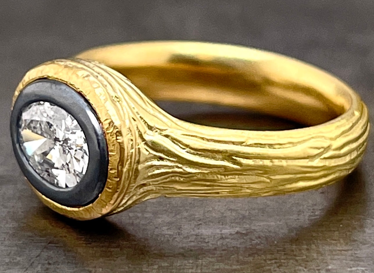 3/4 profile of salt and pepper diamond ring. Here you can better see the bark texture that encompasses the entirety of the gold.