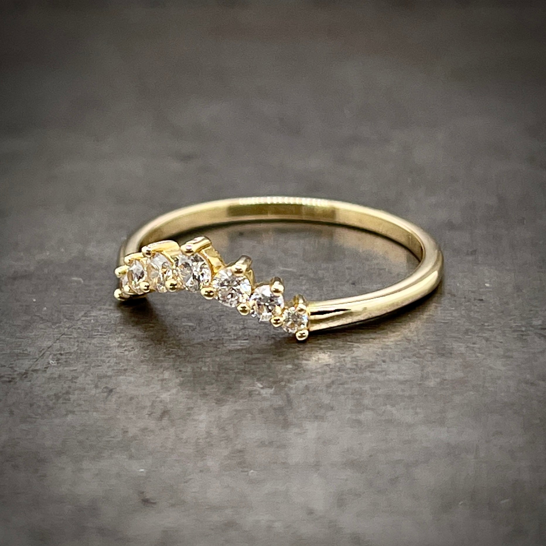 Angled side view of diamond tiara ring.