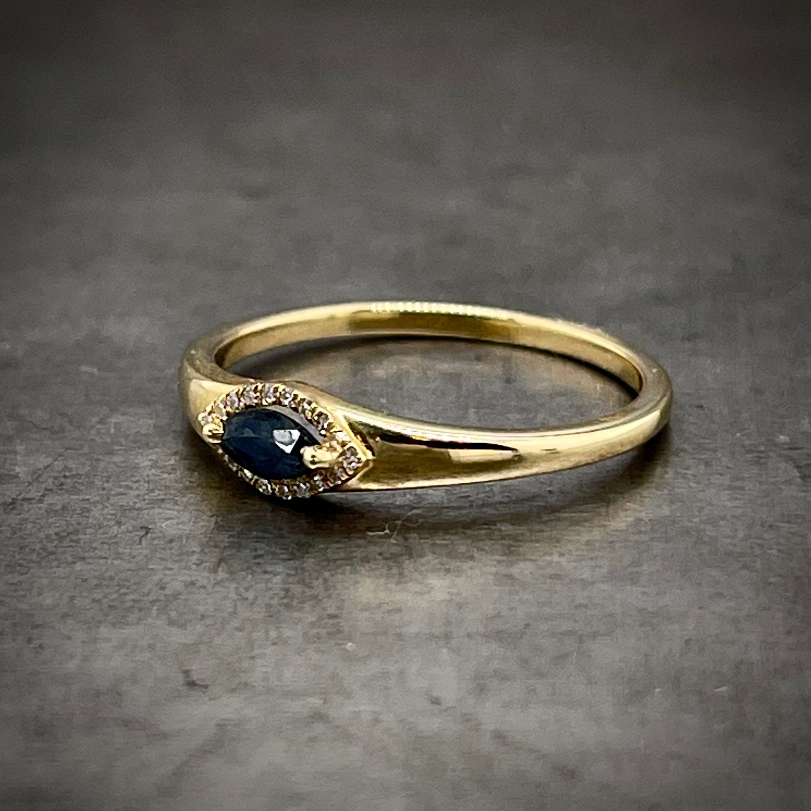 3/4 side view of marquise sapphire ring. 