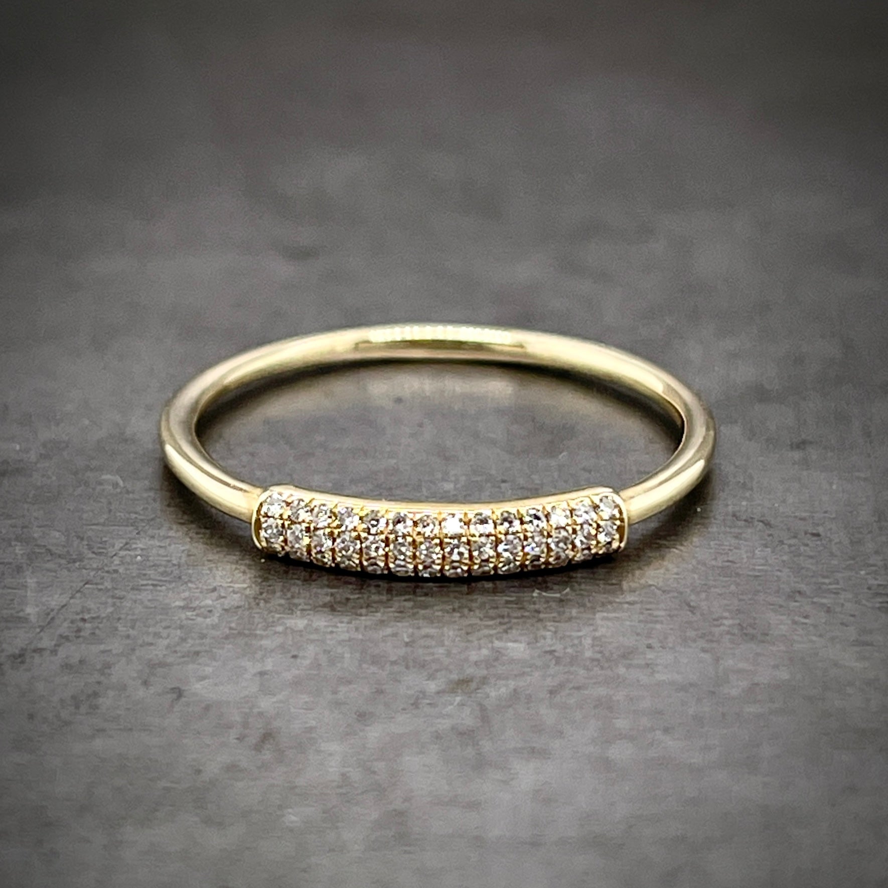 Full view of Diamond and Gold Band. The top of the ring features a slightly larger piece of wire that has two rows of diamonds set in it. The row is 14 diamonds long.