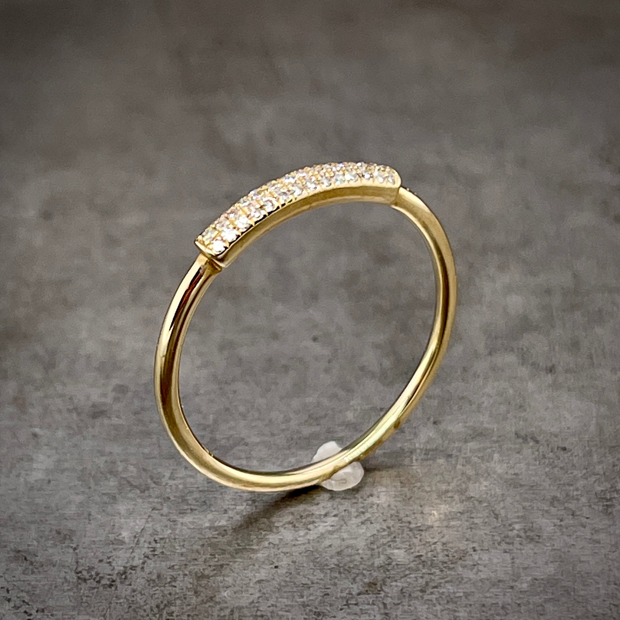 Angled aerial view of diamond and gold band.