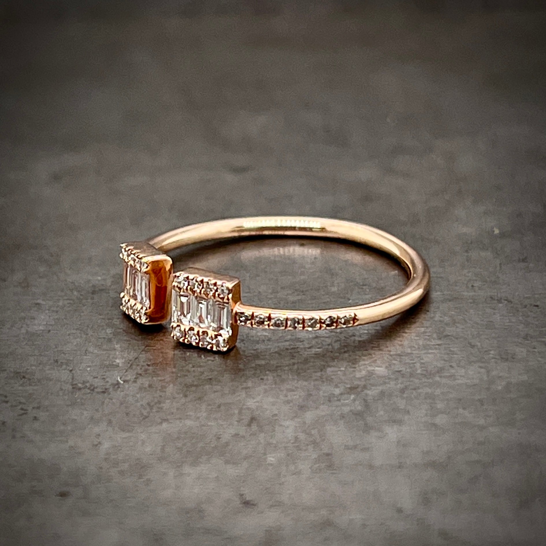 3/4 profile of rose gold negative space ring. Here you can see the diamonds only travel to the shoulders of the ring and do not extend towards the shank.