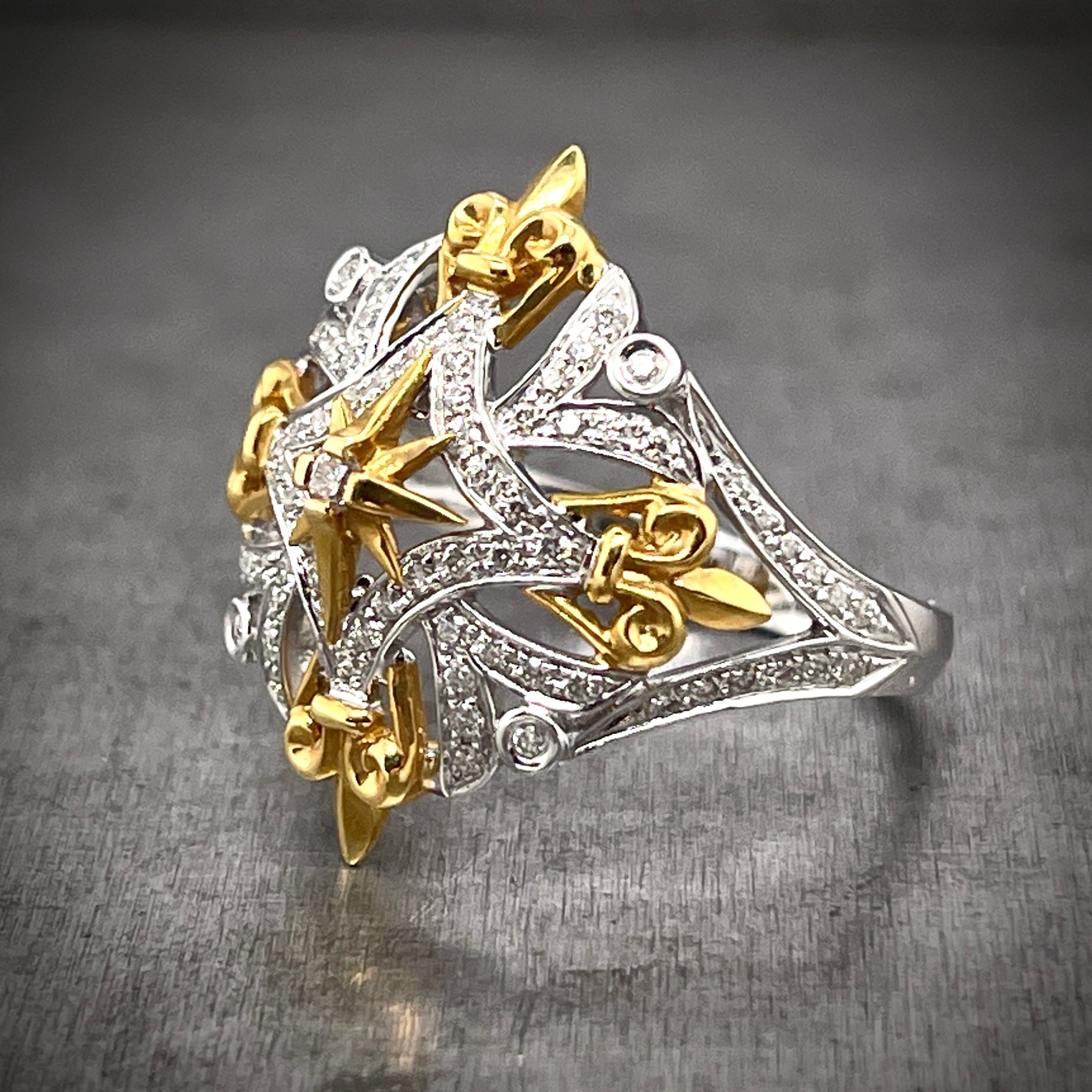 3/4 profile view of Fleur-de-lis ring. Here you can see the diamonds only reach to the shoulder of the ring, and do not extend past them.
