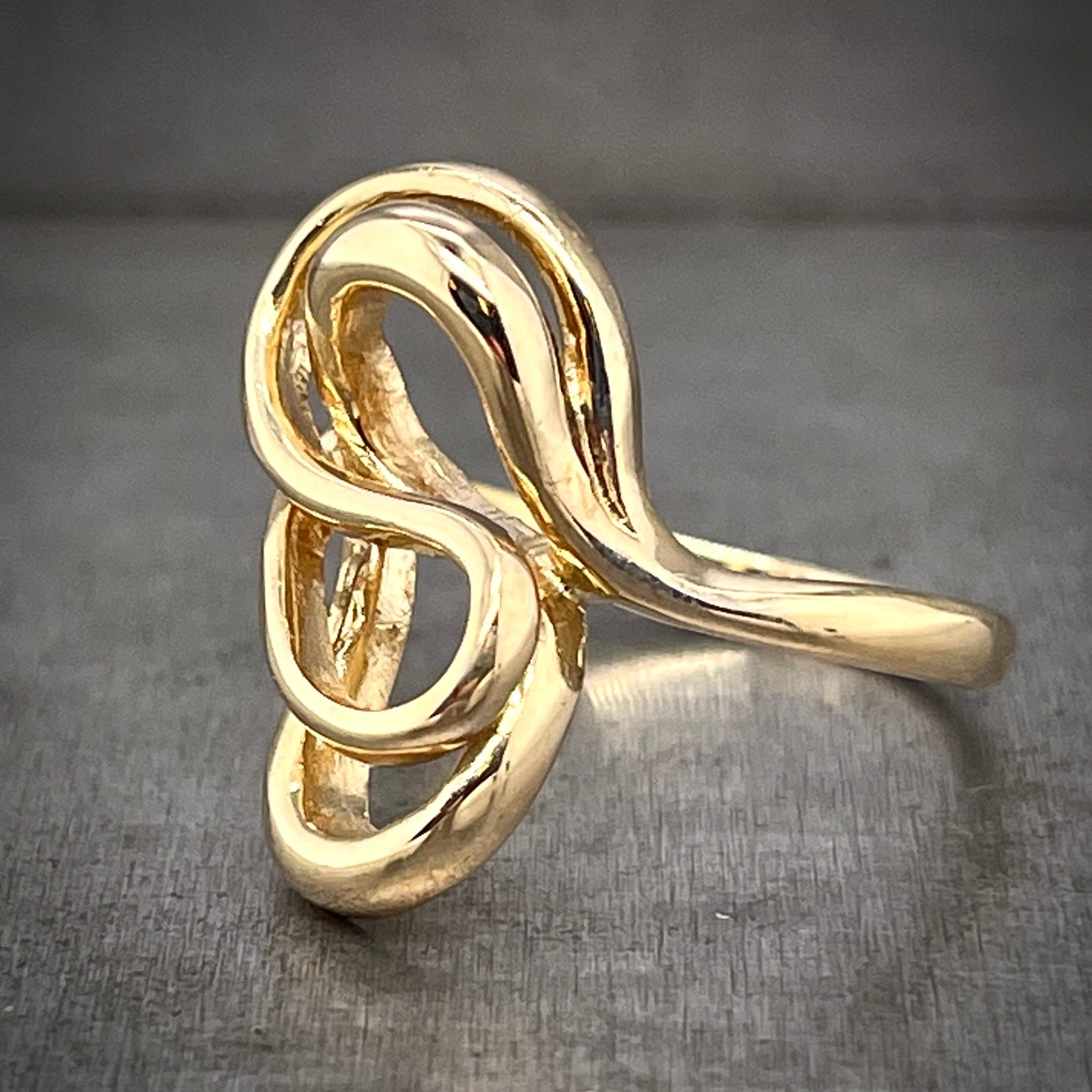 3/4 side profile of abstract gold ring. Here you can see the shank of the ring is one strand of gold wire.