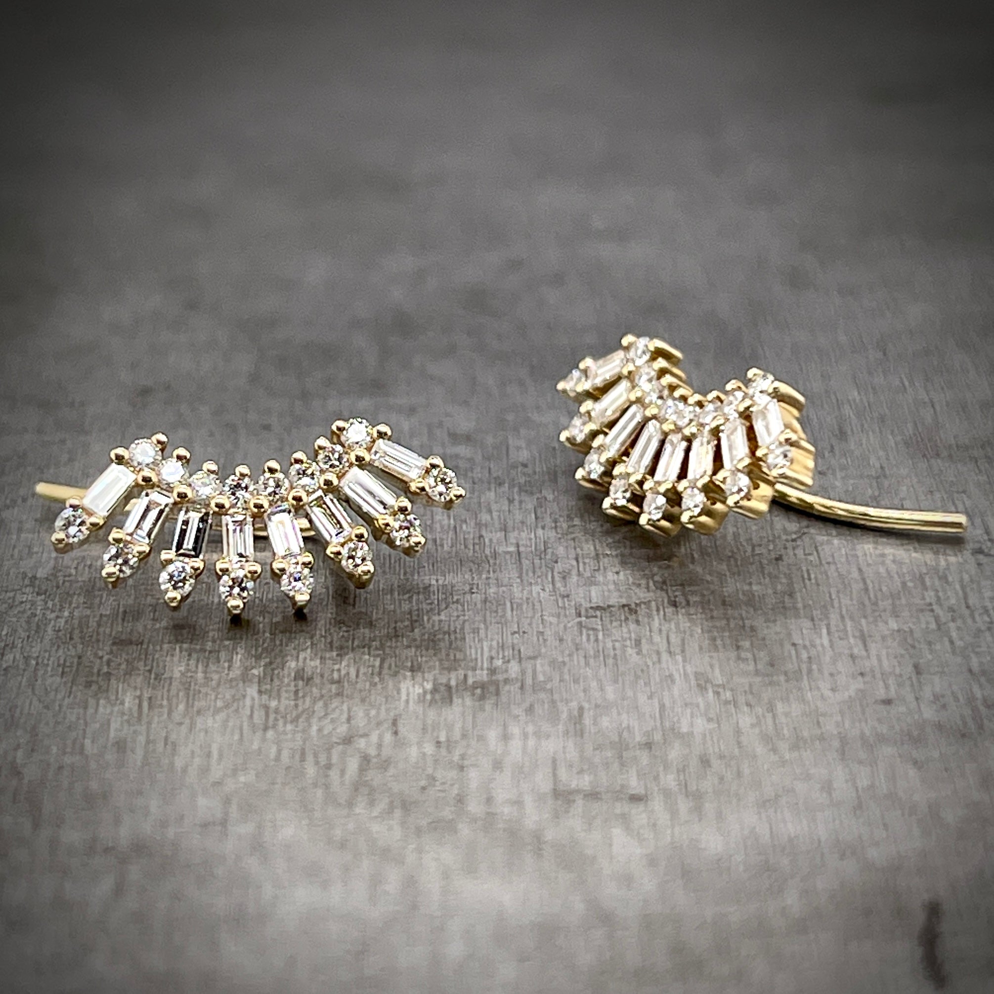 Frontal and 3/4 side profile of floral diamond ear climbers.