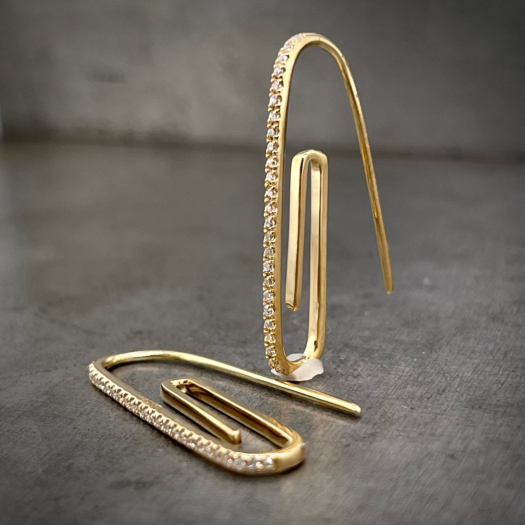 Full view of one paperclip earring standing and one laying down.