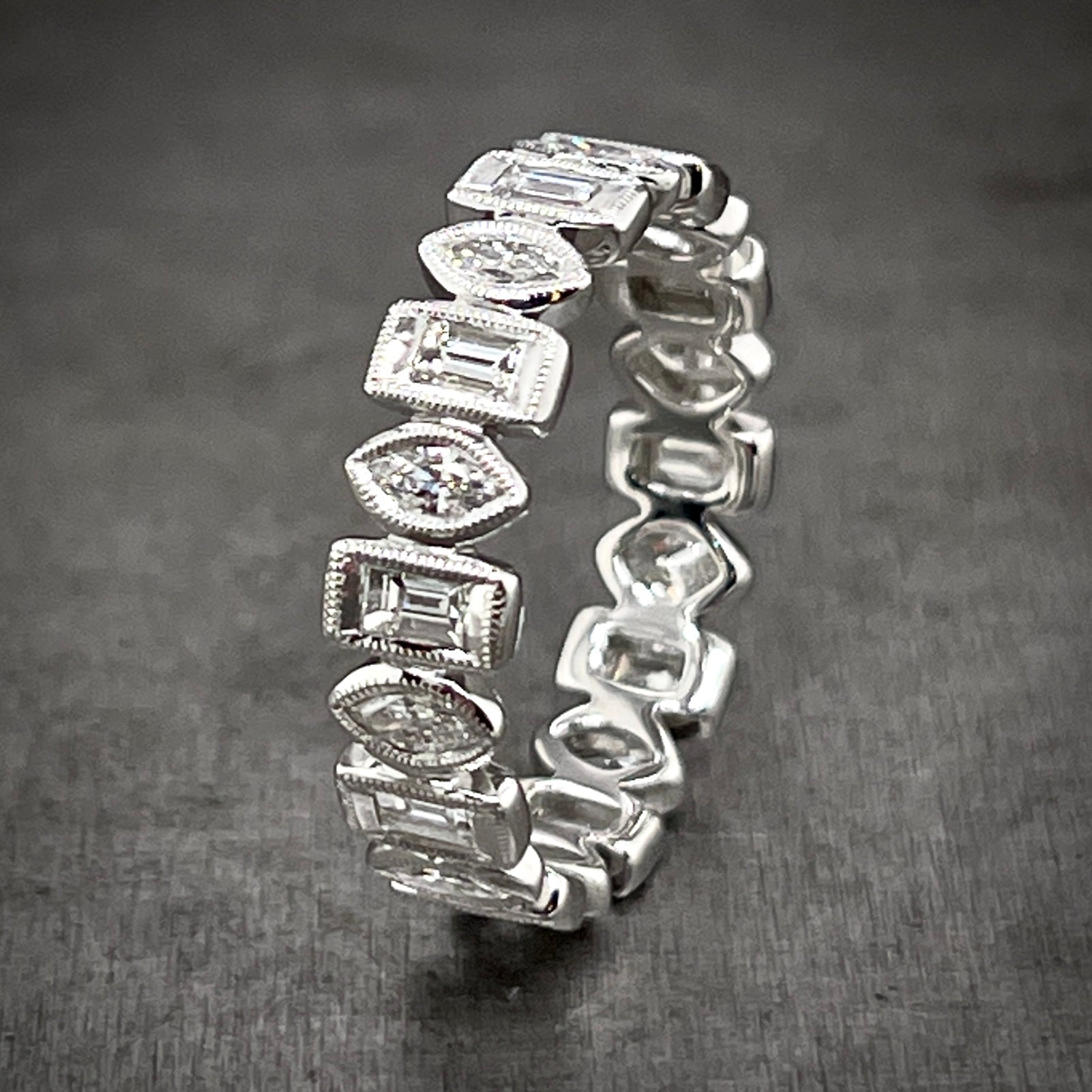 Aerial view of marquise and baguette diamond ring standing up.